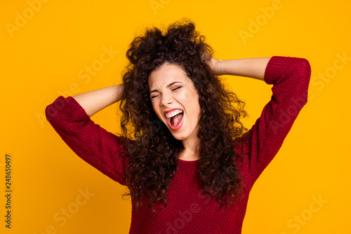 Close up photo amazing charming her she lady stretching after nap eyes closed saw beautiful dream arms in hair wearing red knitted sweater clothes outfit isolated yellow bright background