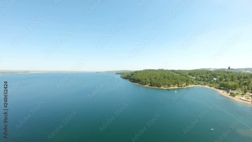 Aerial view of a big river. Drone flies forward above water Aerial view of a big river. Drone flies forward above water