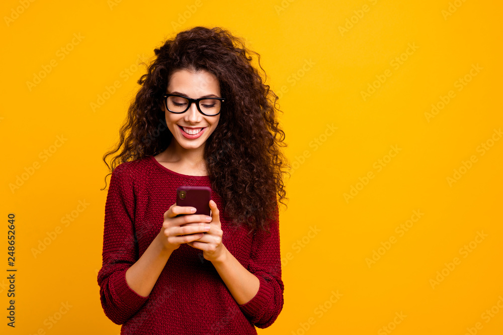 Portrait of her she nice lovely attractive pretty cheerful cheery wavy-haired lady holding in hands cell playing game free time isolated over bright vivid shine orange background - obrazy, fototapety, plakaty 