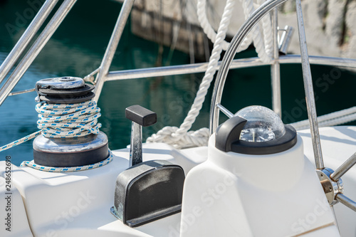 The deck of the yacht in a sunny day. Steering gear of the yacht close-up