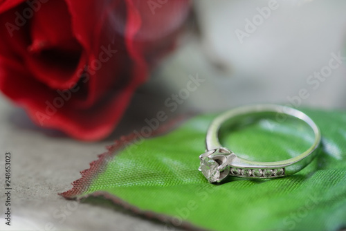 Diamond ring on the leaf of beautiful blossoming rose