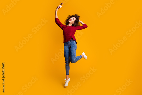 Full length body size view of her she nice cute lovely attractive cheerful slim thin fit wavy-haired lady taking making selfie having fun isolated on bright vivid shine orange background