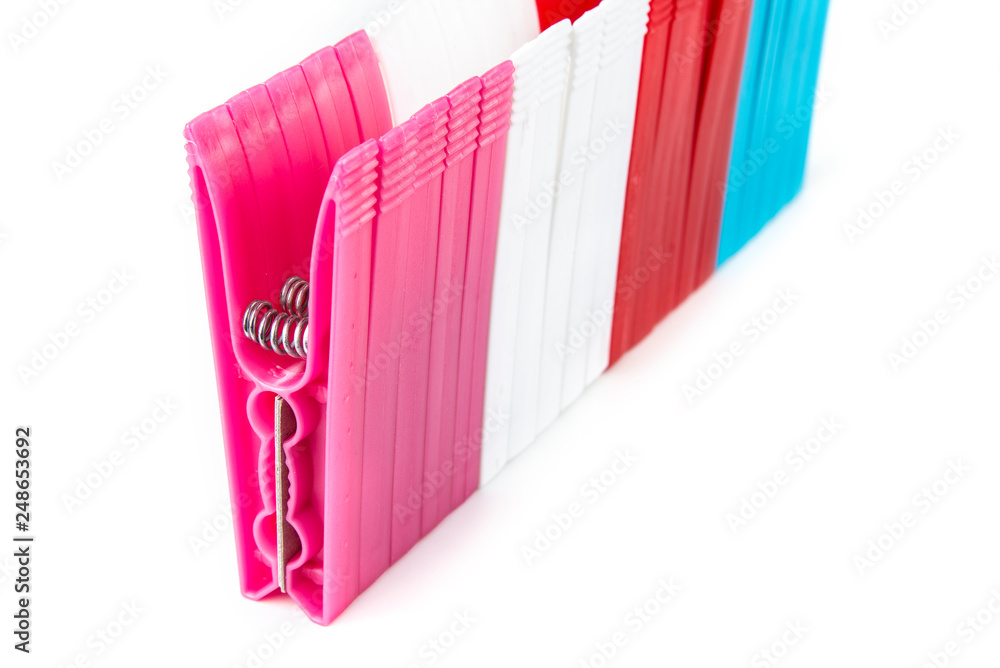 Colorful clothes pegs made of plastic in a row Colorful clothes pegs made of plastic in a row