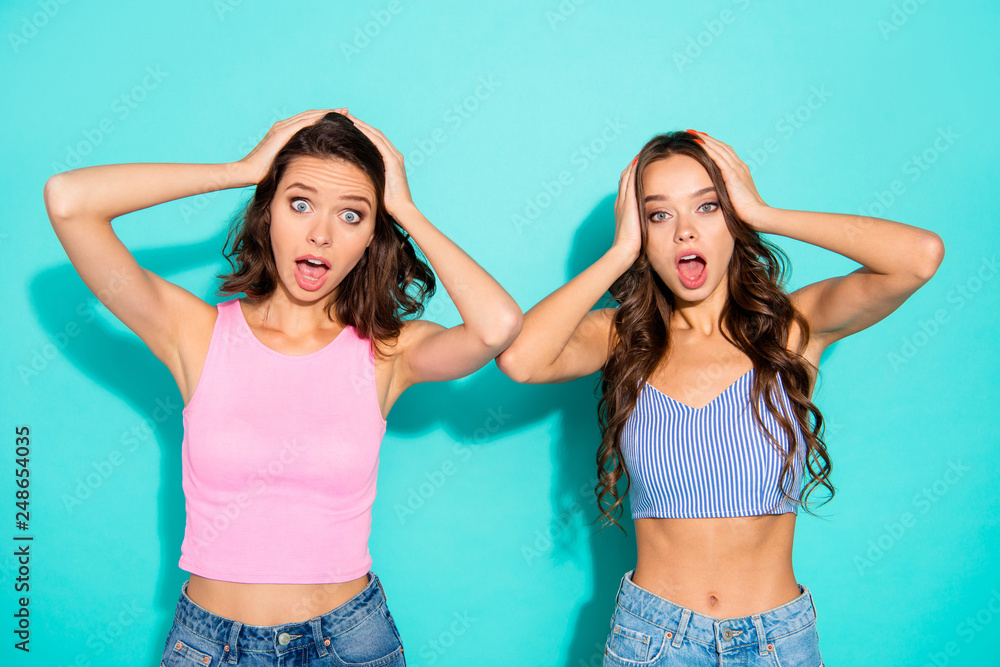 Close up portrait two amazing beautiful yelling she her lady unexpected news open mouth oh no expression arms on head wearing colored shiny shorts tank tops isolated teal bright vivid background Close up portrait two amazing beautiful yelling she her lady unexpected news open mouth oh no expression arms on head wearing colored shiny shorts tank tops isolated teal bright vivid background