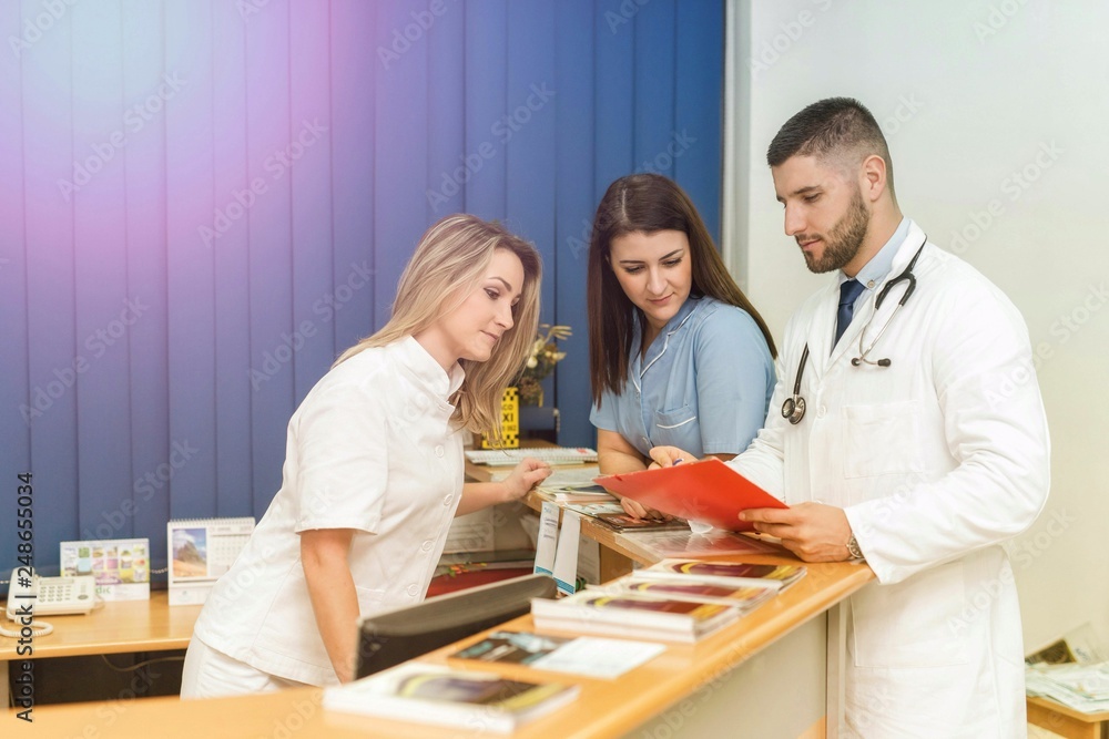 Male doctor and two female nurses inside a hospital, concept Male doctor and two female nurses inside a hospital, concept