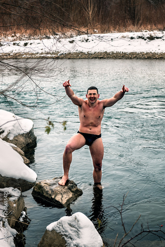 happy healthy man on the winter river