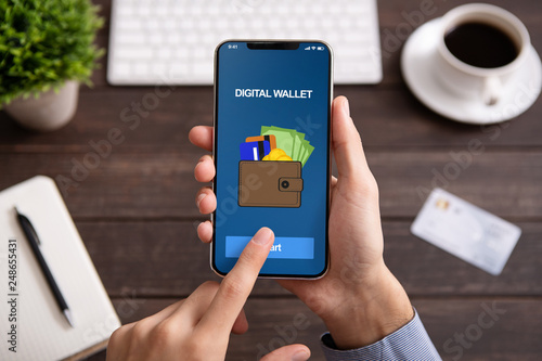 Man holding smartphone with digital wallet application photo
