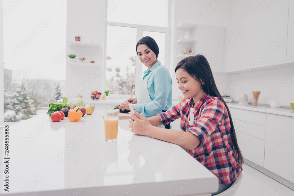 custom made wallpaper toronto digitalProfile side view portrait of two nice cute lovely sweet attractive stylish trendy cheerful people girl using cell mom making meal in light white kitchen interior
