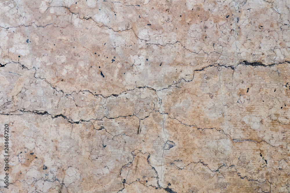 Detailed beige cracked stone surface, texture of old natural marble