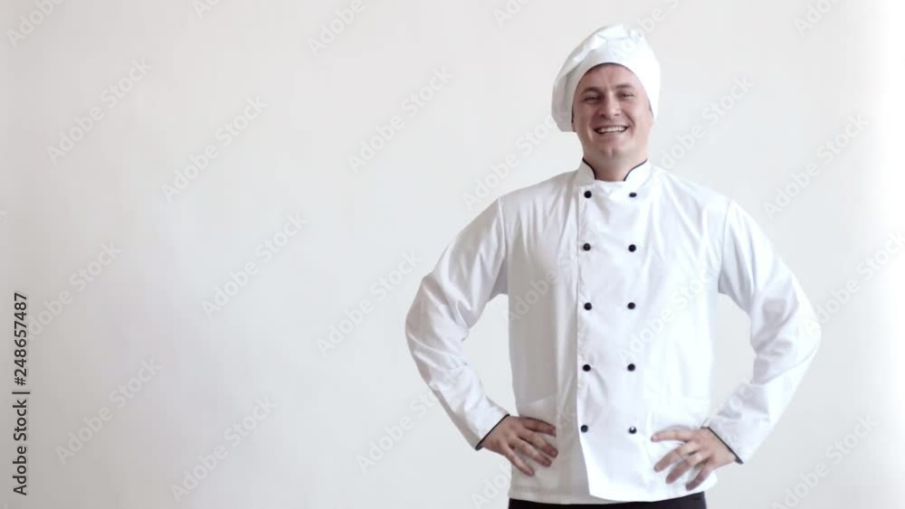 Cook man holding hands on his belt, laughing at the camera, then crosses his arms on his chest Cook man holding hands on his belt, laughing at the camera, then crosses his arms on his chest