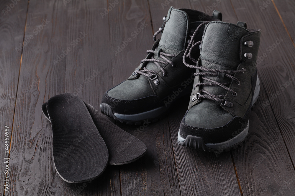 Warm shoes and orthopedic insoles. Winter background, footwear
