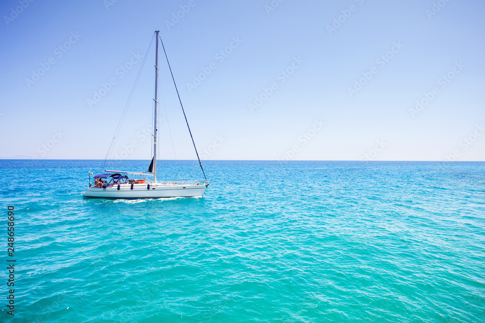 Beautiful bay with sailing boat yacht. Sailboat in a sea. Yachting, travel and active lifestyle concept
