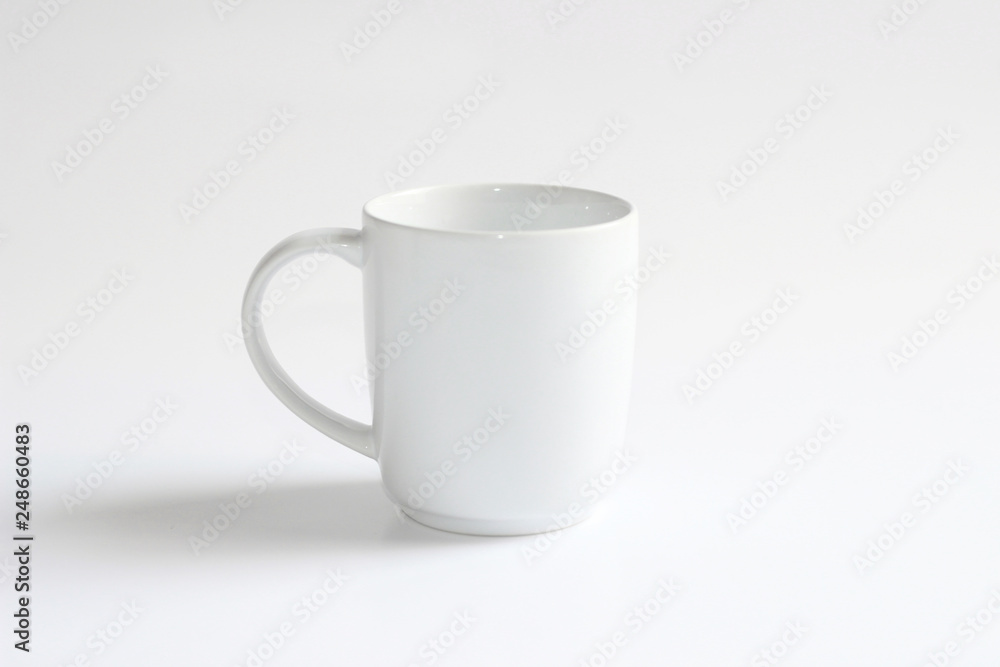 White ceramic mug. Isolated on a white. White ceramic mug. Isolated on a white.