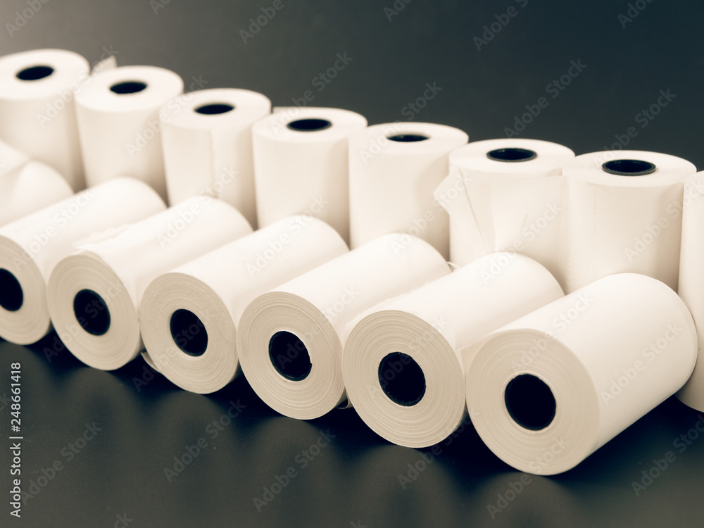 tape of white paper for cash on a black background. tape of white paper for cash on a black background.
