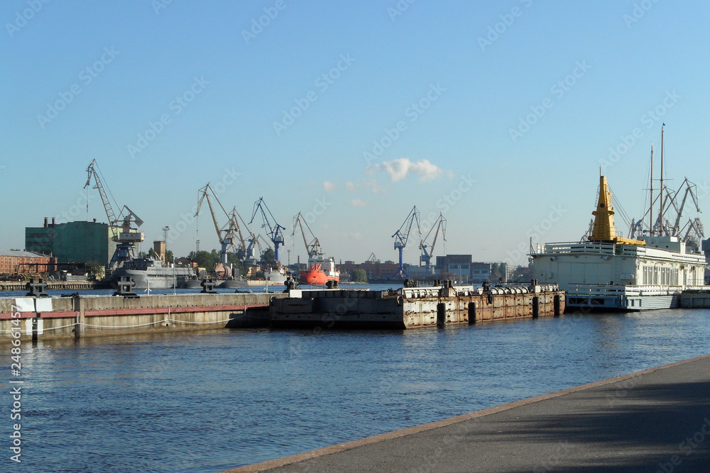 commercial port, shipping conteiners terminal and freight cranes