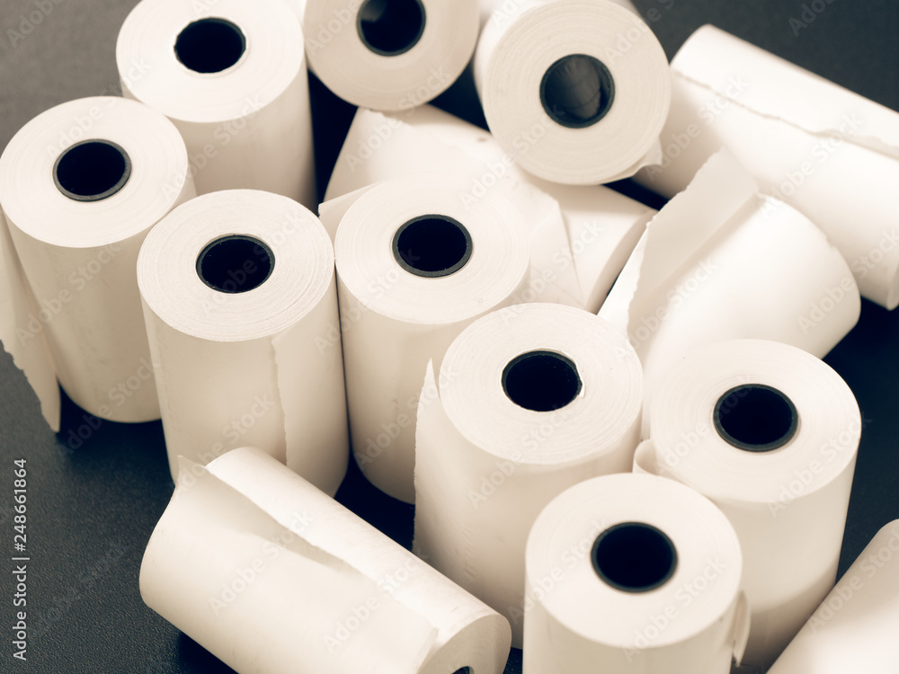 tape of white paper for cash on a black background. tape of white paper for cash on a black background.
