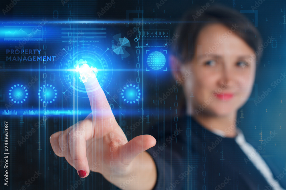 The concept of business, technology, the Internet and the network. A young entrepreneur working on a virtual screen of the future and sees the inscription: Property management The concept of business, technology, the Internet and the network. A young entrepreneur working on a virtual screen of the future and sees the inscription: Property management