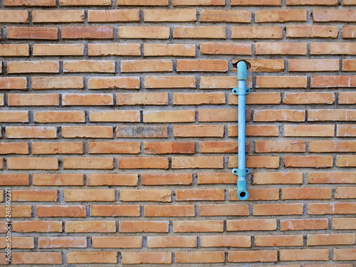 Red brick wall with pvc pipe With copy space. Selective focus