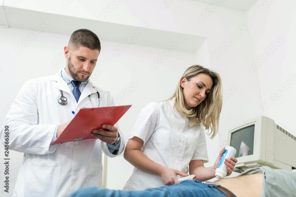 Male doctor and female nurse checking on their patients health Male doctor and female nurse checking on their patients health