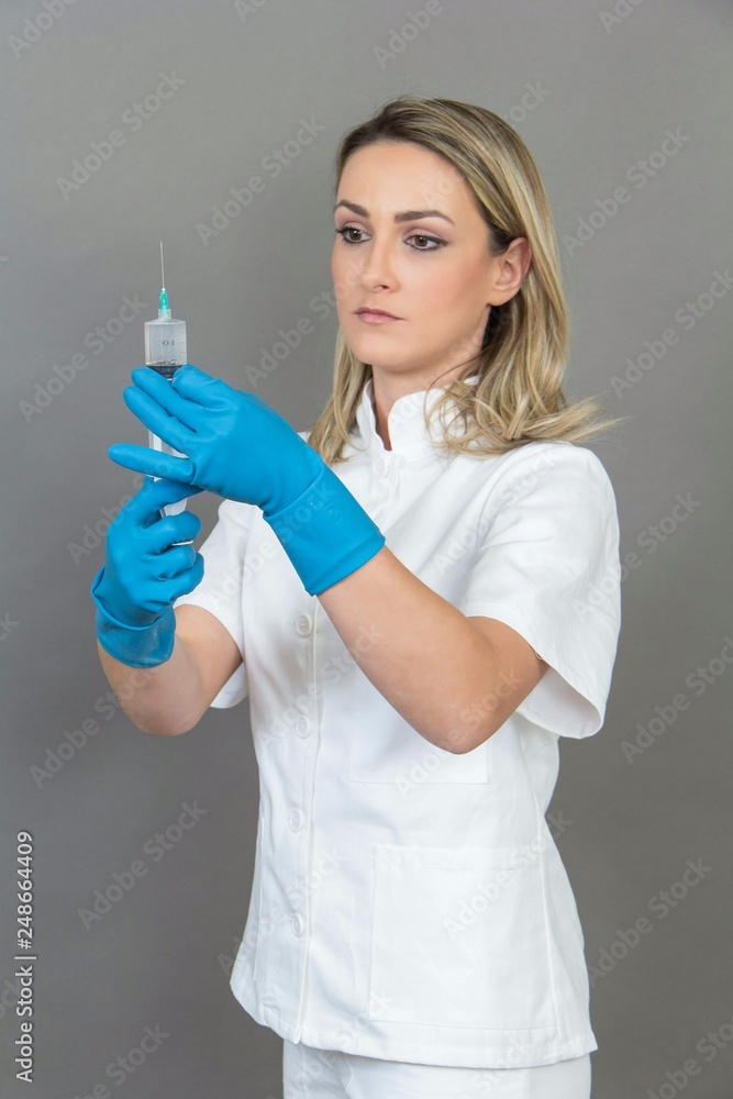 Female nurse on grey background, isolated Female nurse on grey background, isolated