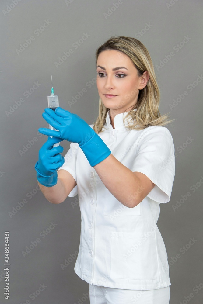 Female nurse on grey background, isolated Female nurse on grey background, isolated