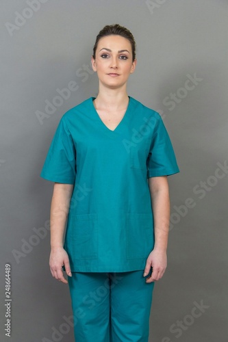 Female nurse on grey background, isolated