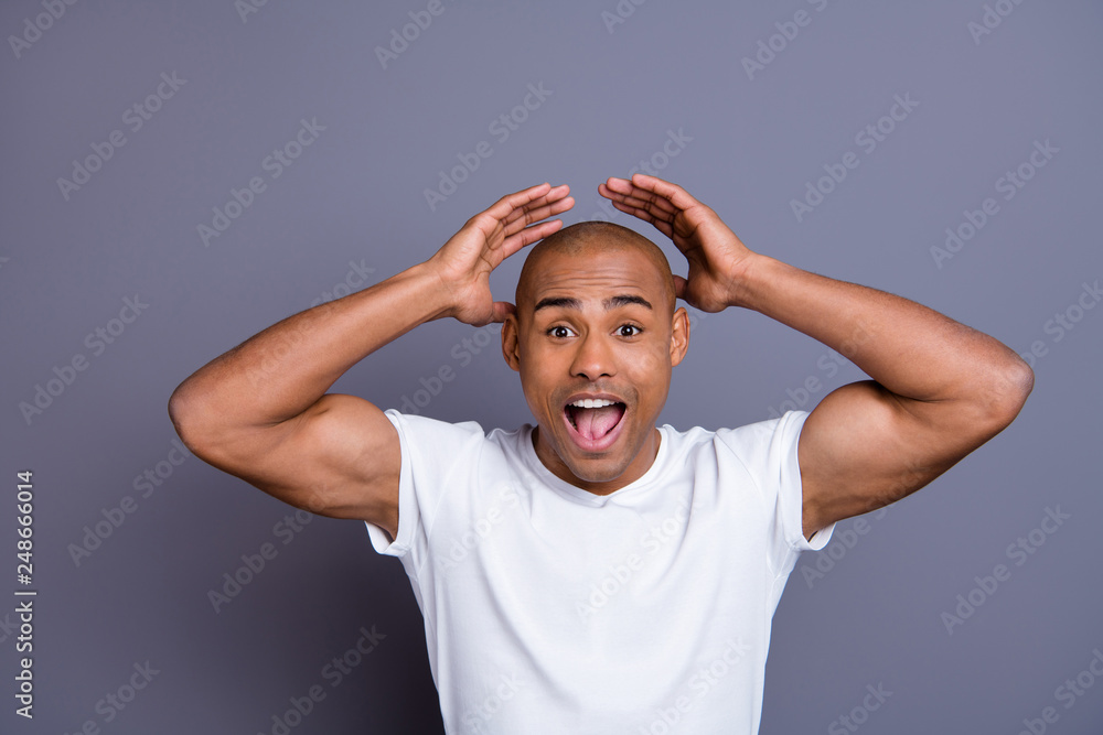 Close up photo strong healthy dark skin he him his macho bald head mouth opened yell with all voice hands arms raised wondered wearing white t-shirt outfit clothes isolated grey background Close up photo strong healthy dark skin he him his macho bald head mouth opened yell with all voice hands arms raised wondered wearing white t-shirt outfit clothes isolated grey background