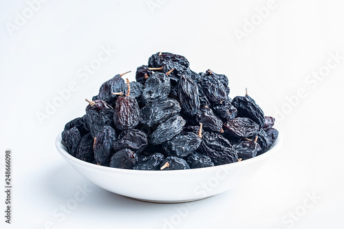 Black currant dried on white background