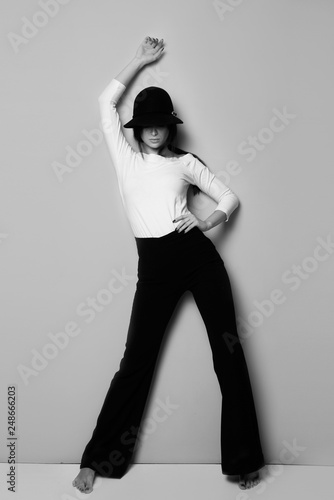 Black and white photo fashion model posing beautiful girl young woman in black and white outfit