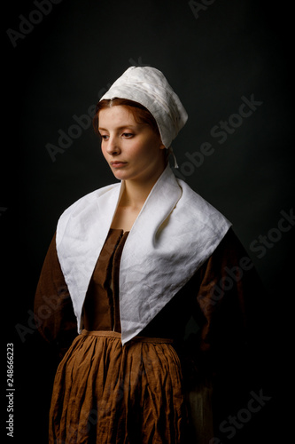 Medieval maid posing in studio photo