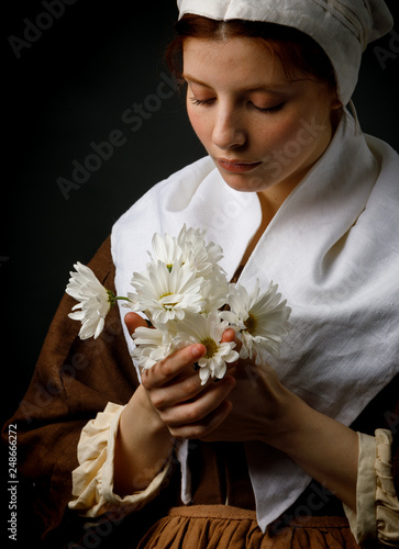 Medieval maid holding flowers photo