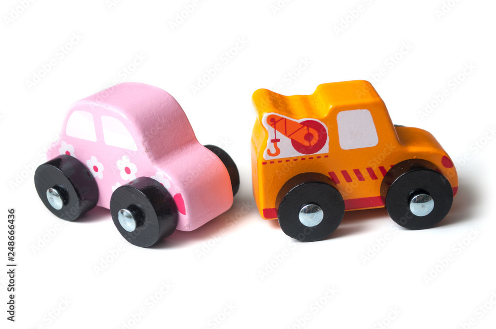 closeup of miniature wooden tow truck on white background - concept help on the road closeup of miniature wooden tow truck on white background - concept help on the road