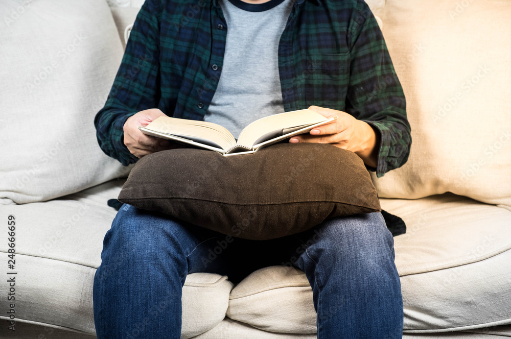 Fototapeta premium young man read a book on the sofa