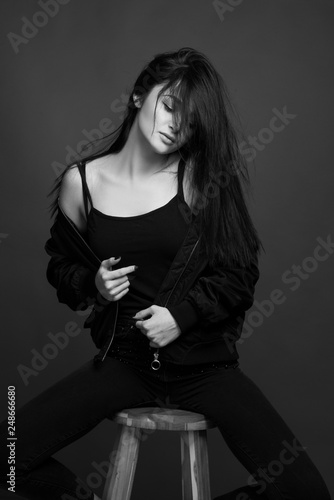 Black and white photo fashion model posing beautiful girl young woman in black and white outfit