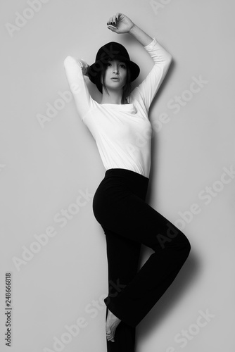 Black and white photo fashion model posing beautiful girl young woman in black and white outfit