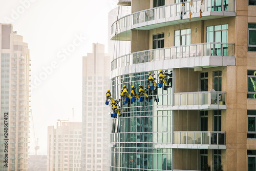 Canvas Print Group of window cleaners washing the glass