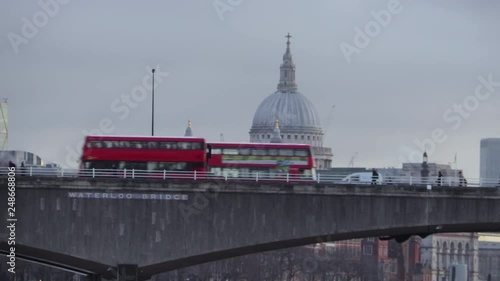 London Buses go past St Paul's Cathedral at dawn