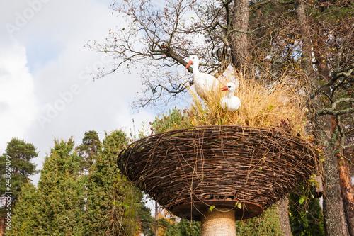 KOTKA, FINLAND - OCTOBER 23, 2018: White artificial storks in the nest as a part of a landscape design in the water park Sapokka. Kotka, Finland photo