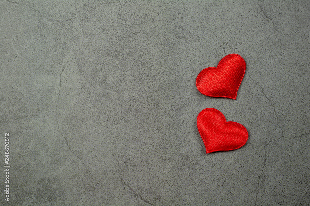 Fototapeta premium Valentines day background with red hearts on old concrete table. - Love and care concept.