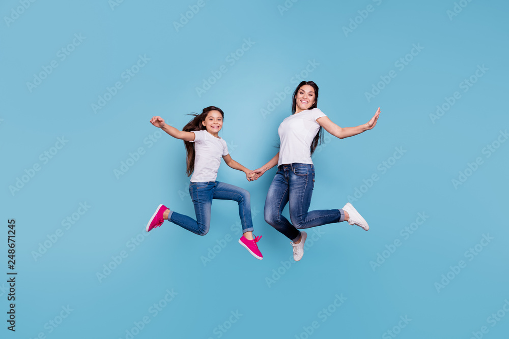 Full length body size view of two nice cute free lovely attractive cheerful cheery slim sporty people in white t-shirt holding hands having fun isolated over blue pastel background