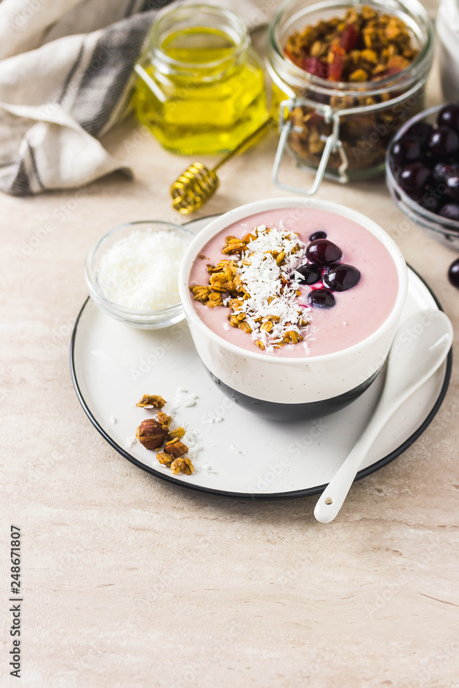 Granola smoothie bowl with frozen berries. Selective focus, space for text.