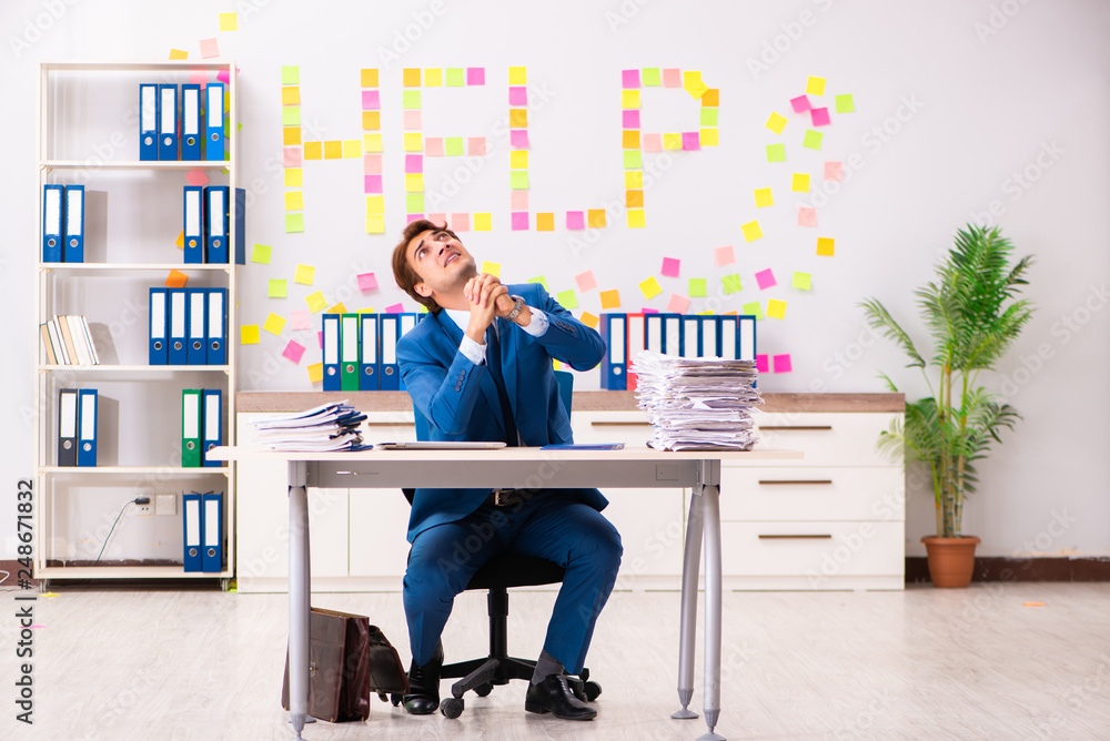 Young employee suffering from excessive work Young employee suffering from excessive work