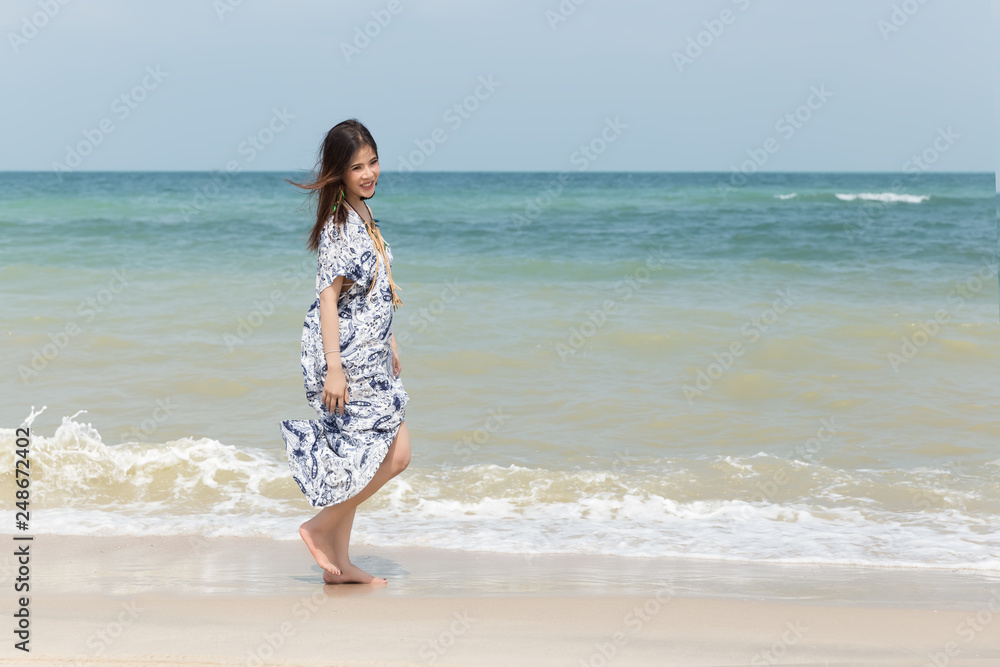 In sunny day holiday summer,Beautiful woman walk,relax and happy on beach.for good health In sunny day holiday summer,Beautiful woman walk,relax and happy on beach.for good health