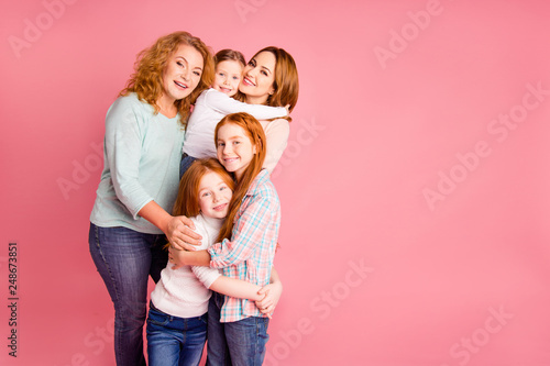 Close up family girlish present photo set foxy little girls mom granny five stand close tight smile glad vacation spend free time wear sweaters shirts pullovers isolated on rose background #248673851