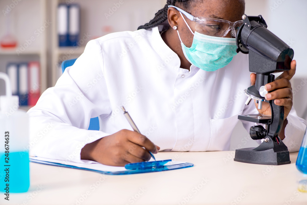 Young black chemist working in the lab Young black chemist working in the lab