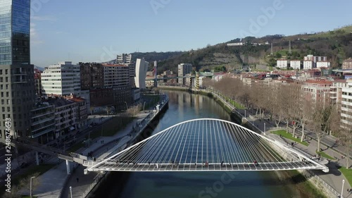 Aerial; drone view of Bilbao capital of Basque country; city panorama with modern architecture and contemporary art objects; new life of ancient city; the combination of old town and modern urbanism photo