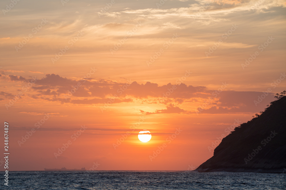 beautiful sunset on the beach of itacoatiara in niterói, rio de janeiro, brazil