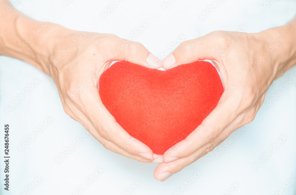 handsome man holding red heart in hands and making heart shape gesture sign body language giving for love life healthy care medicine hospital concept and lovely romantic for valentines day. handsome man holding red heart in hands and making heart shape gesture sign body language giving for love life healthy care medicine hospital concept and lovely romantic for valentines day.