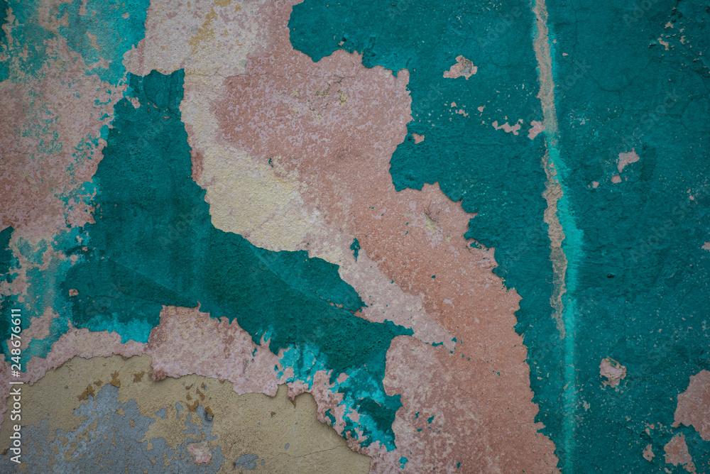 texture of old and peeling green paint on concrete wall