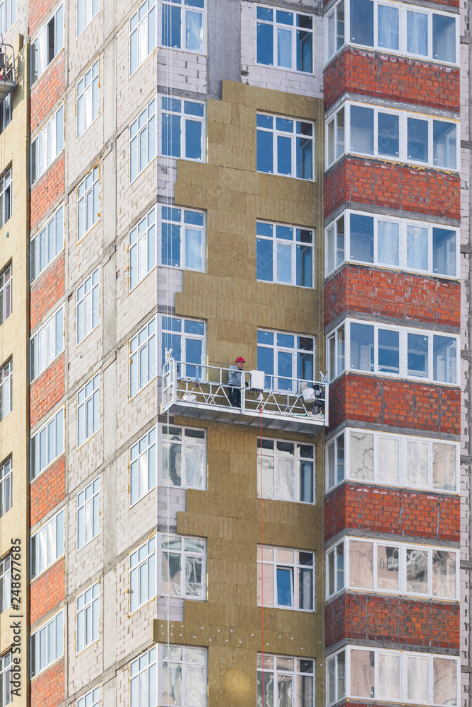 Facade work and insulation of a multistory building Facade work and insulation of a multistory building